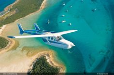 Rick Gardner and Anton Leonhardes fly Rick's Cessna 337 over the clear waters of The Bahamas.